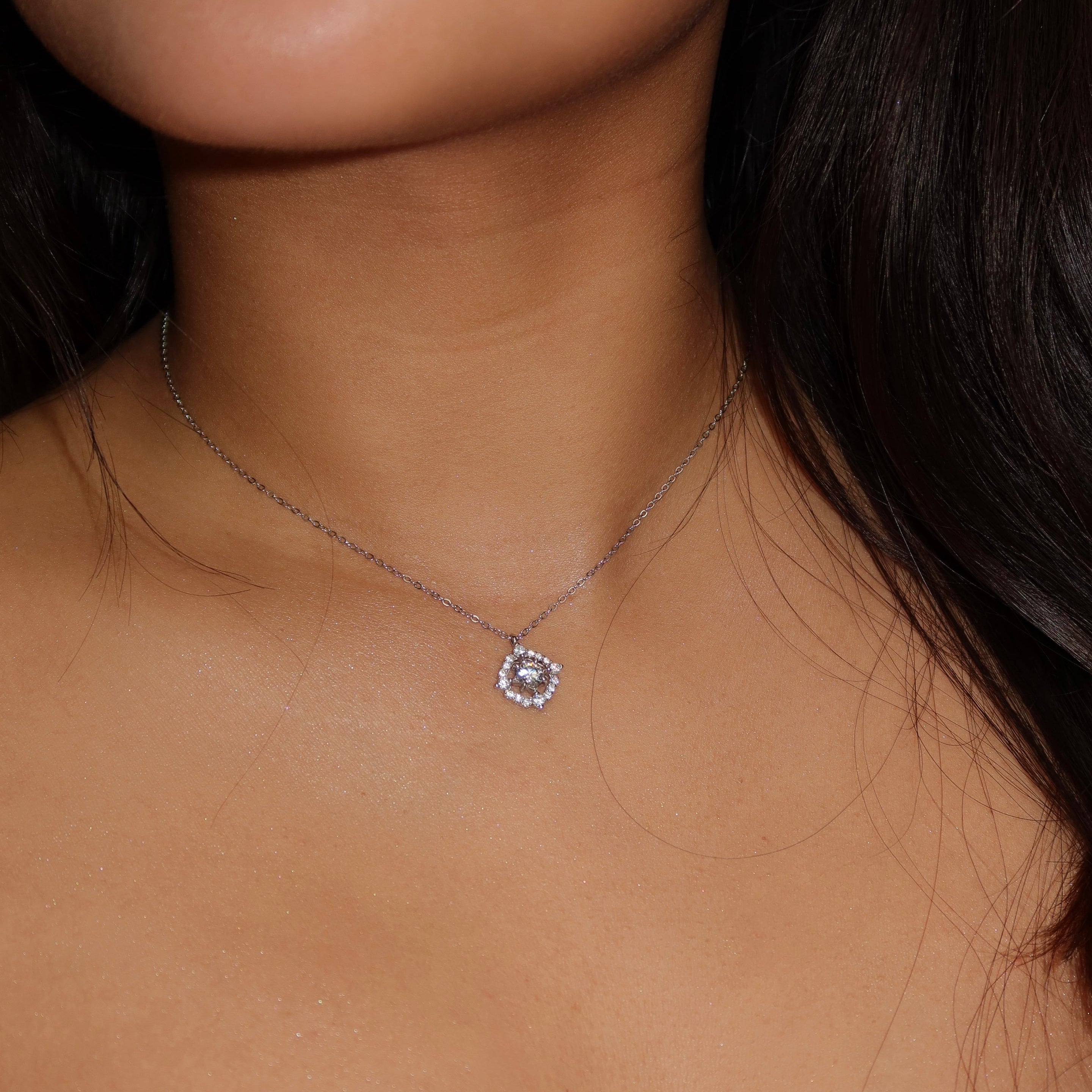 Sterling silver square halo necklace with brilliant-cut stones from Atemorae, worn close to the collarbone for an elegant, minimalist look.